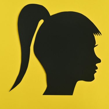 young woman head silhouette on yellow background young woman head silhouette on yellow background